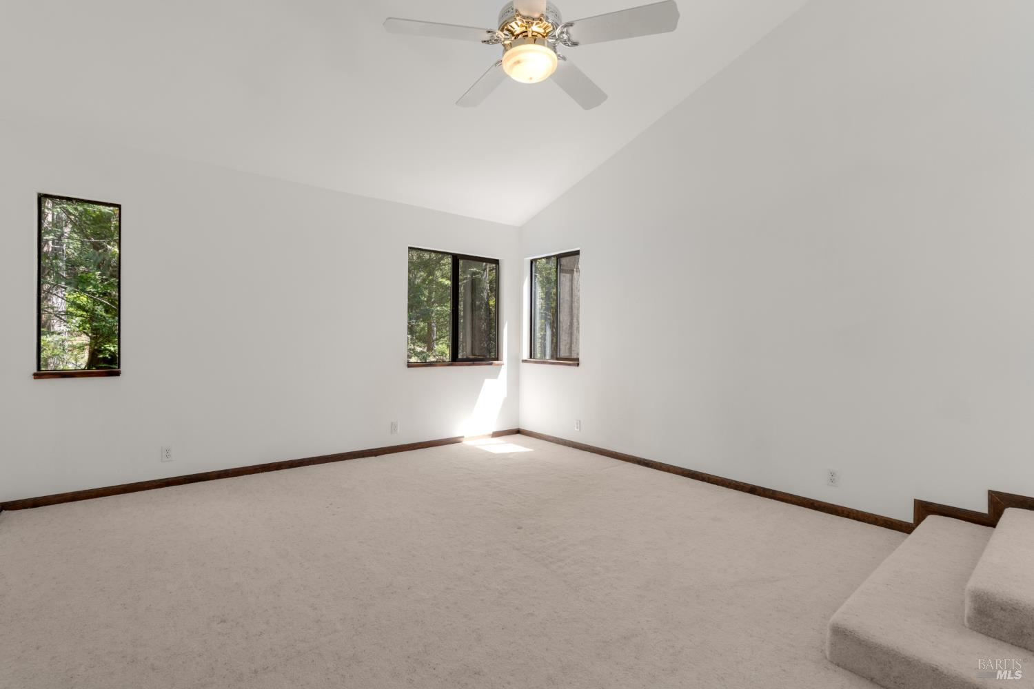 355 Chinquapin Lane The Sea Ranch, CA 95497 - Photo 17 of 31 an empty room with windows and fan