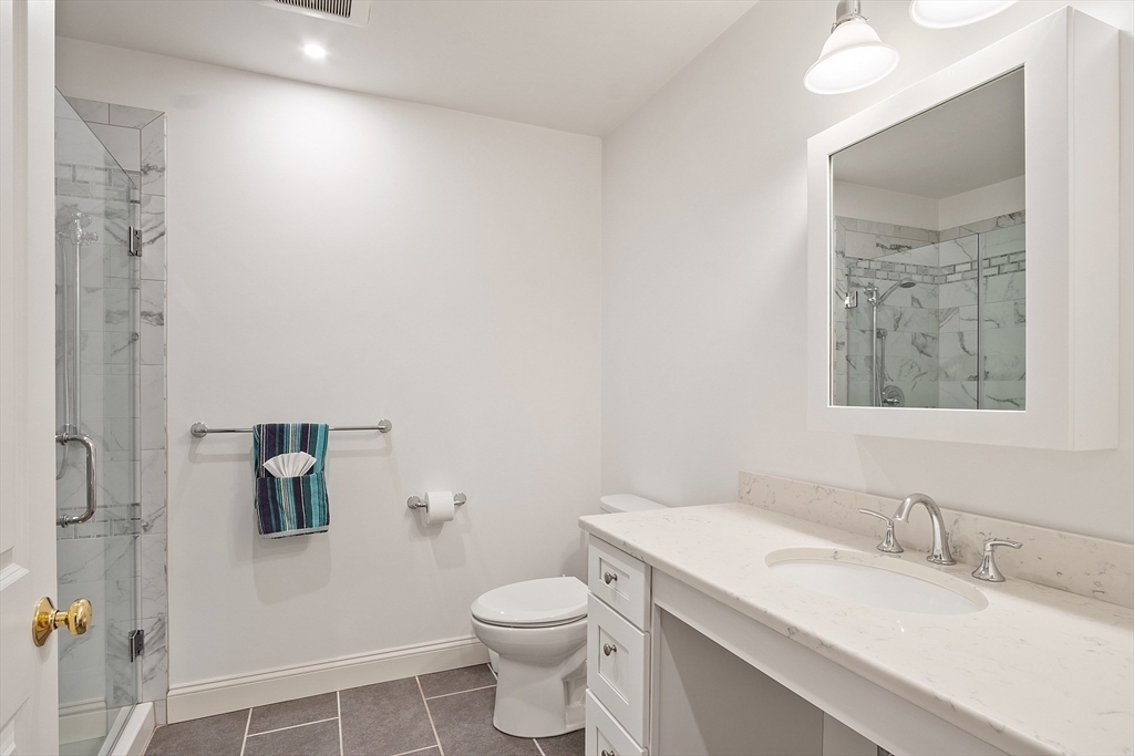 38 Plover Hill Road Ipswich, MA 01938 - Photo 16 of 42 a bathroom with a granite countertop sink a mirror and a toilet