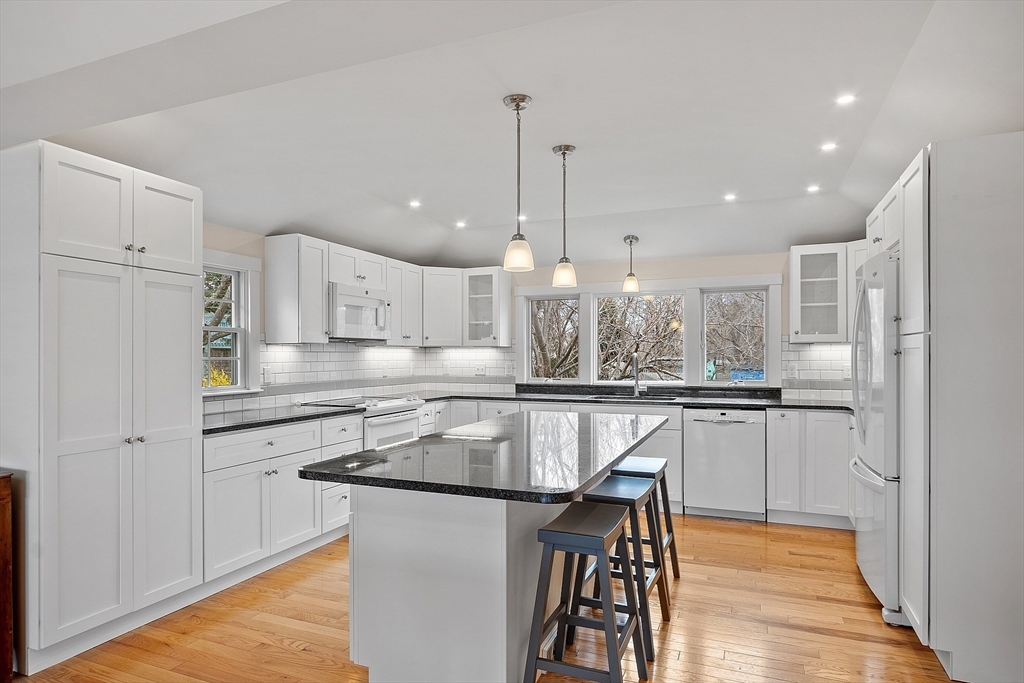 38 Plover Hill Road Ipswich, MA 01938 - Photo 4 of 42 a kitchen with stainless steel appliances granite countertop a kitchen island hardwood floor sink and stove