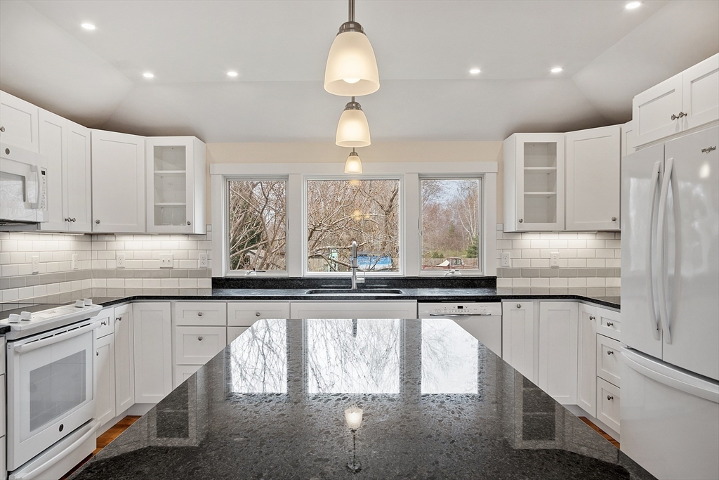 38 Plover Hill Road Ipswich, MA 01938 - Photo 5 of 42 a kitchen with stainless steel appliances granite countertop a sink a stove and a refrigerator