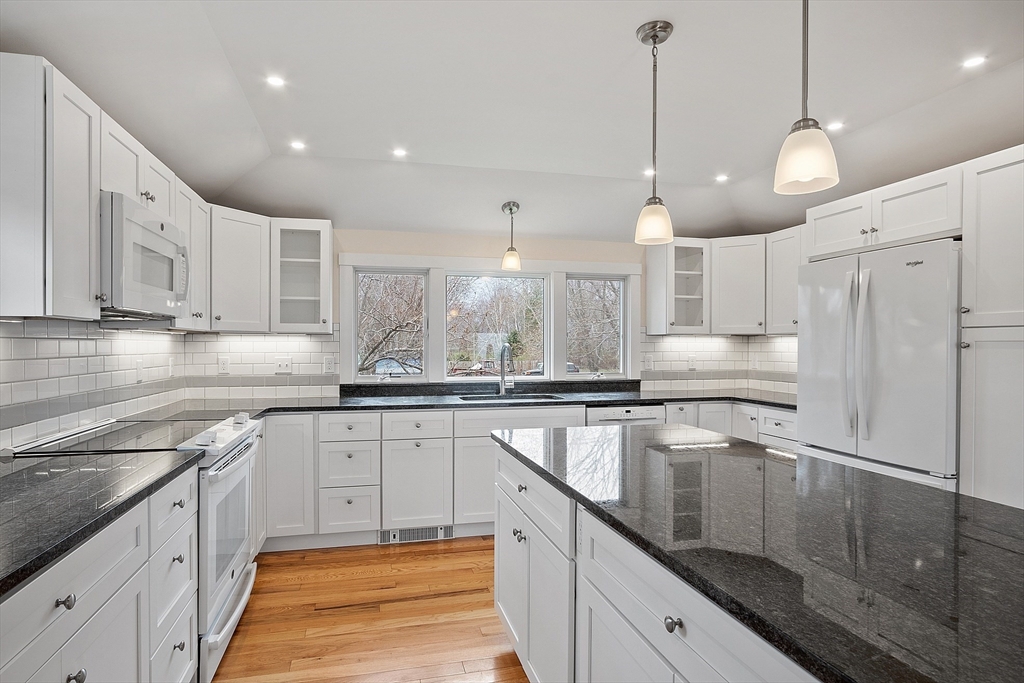 38 Plover Hill Road Ipswich, MA 01938 - Photo 6 of 42 a kitchen with stainless steel appliances granite countertop a sink a stove and a refrigerator