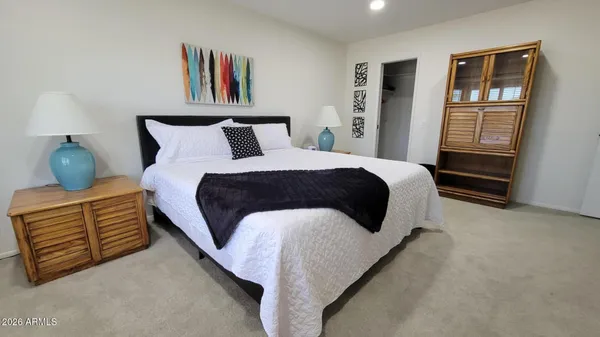 a kitchen with stainless steel appliances wooden floor and a refrigerator