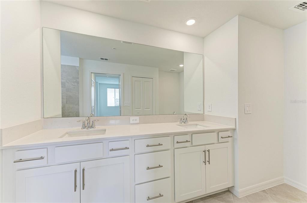 19015 Scallop Loop, Unit 7118 Lakewood Ranch, FL 34211 - Photo 23 of 48 a bathroom with a sink and a mirror