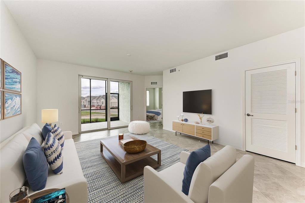 19015 Scallop Loop, Unit 7118 Lakewood Ranch, FL 34211 - Photo 32 of 48 a living room with furniture and a flat screen tv