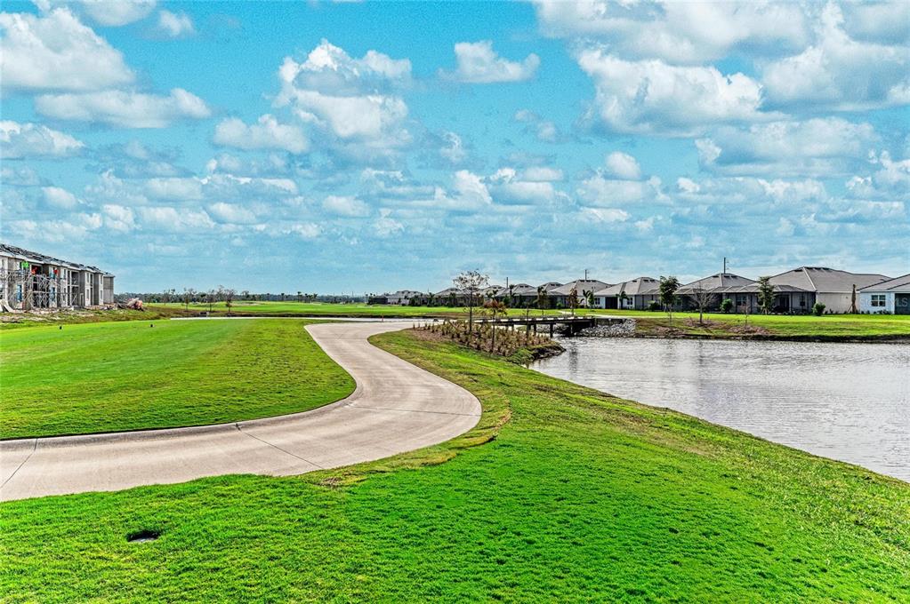 19015 Scallop Loop, Unit 7118 Lakewood Ranch, FL 34211 - Photo 38 of 48 a view of a lake with a big yard