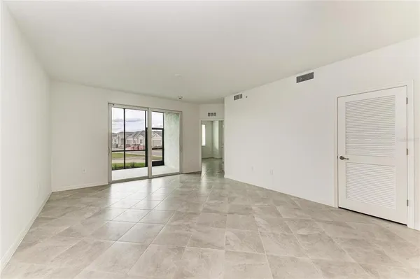 a view of a big room with wooden cabinet and windows