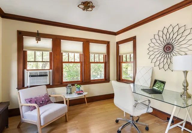 a living room with furniture and floor to ceiling windows