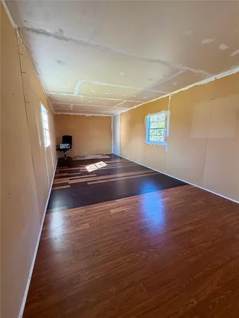 a view of room with window and wooden floor