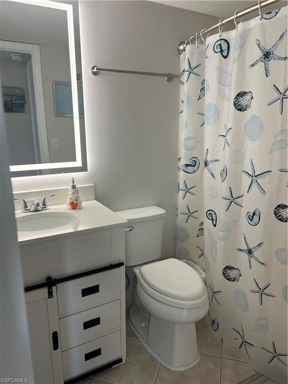 4346 27th Court Southwest, Unit 102 Naples, FL 34116 - Photo 12 of 15 a bathroom with a sink toilet and shower