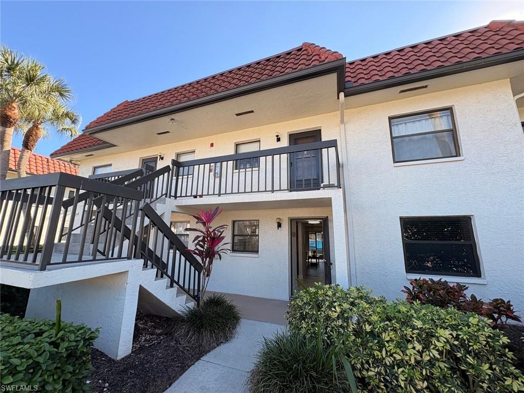 4346 27th Court Southwest, Unit 102 Naples, FL 34116 - Photo 14 of 15 a front view of a house with balcony