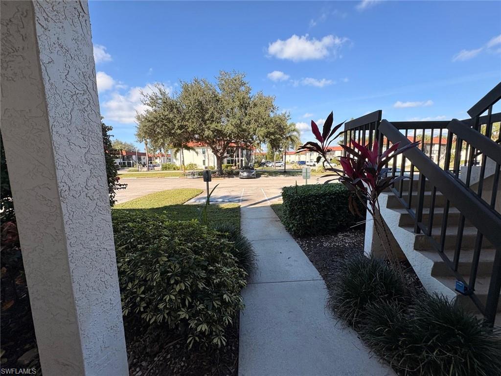 4346 27th Court Southwest, Unit 102 Naples, FL 34116 - Photo 15 of 15 a view of a pathway with a yard