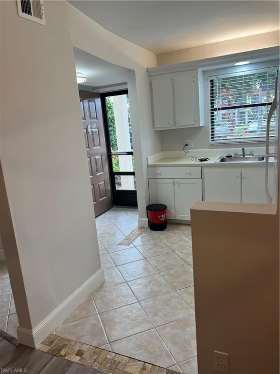 4346 27th Court Southwest, Unit 102 Naples, FL 34116 - Photo 5 of 15 a kitchen with a cabinets and a stove top oven