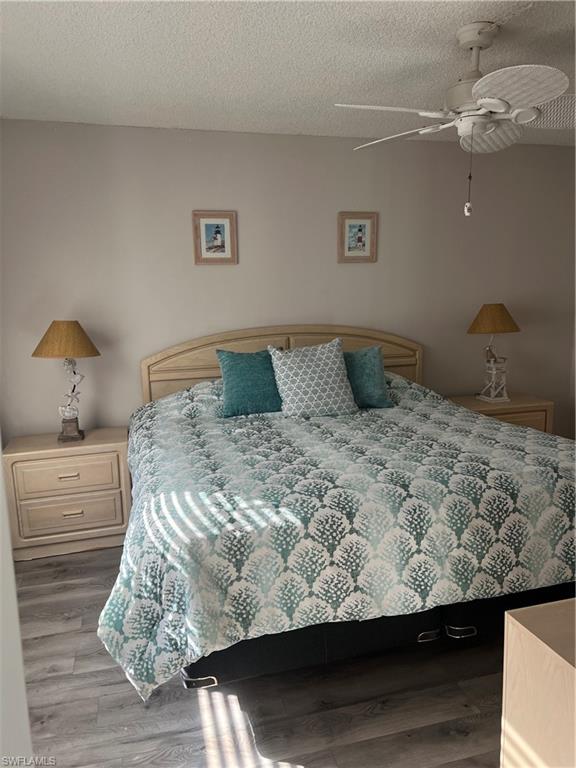 4346 27th Court Southwest, Unit 102 Naples, FL 34116 - Photo 7 of 15 a bedroom with a bed and dresser