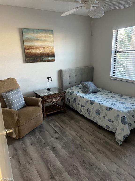 4346 27th Court Southwest, Unit 102 Naples, FL 34116 - Photo 9 of 15 a bedroom with a bed couch and a window