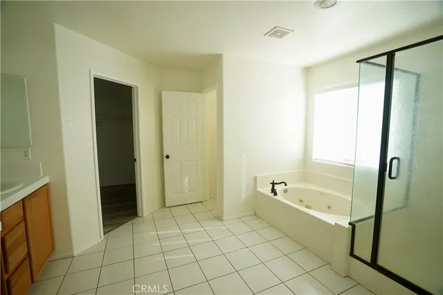 an empty room with wooden floor and mirror