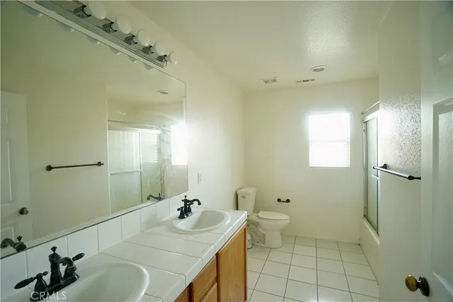 a view of a white house next to a yard