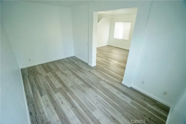 a large kitchen with stainless steel appliances kitchen island granite countertop a refrigerator and a sink