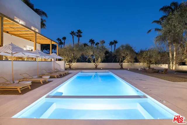 a view of a swimming pool with an outdoor seating