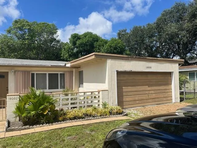 a front view of a house with yard