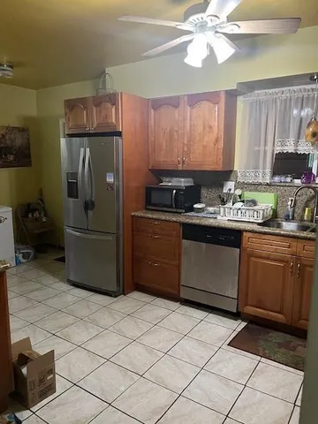 a kitchen with stainless steel appliances a sink cabinets and a counter top space