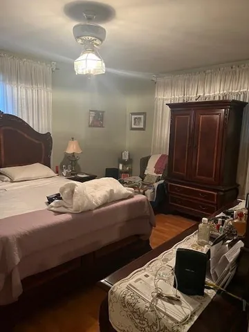 a bedroom with bed and window