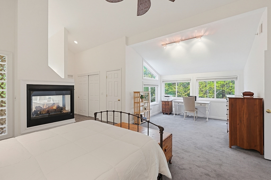 3002 Maple Brook Road, Unit 3002 Bellingham, MA 02019 - Photo 19 of 42 a living room with furniture a large window and a fireplace