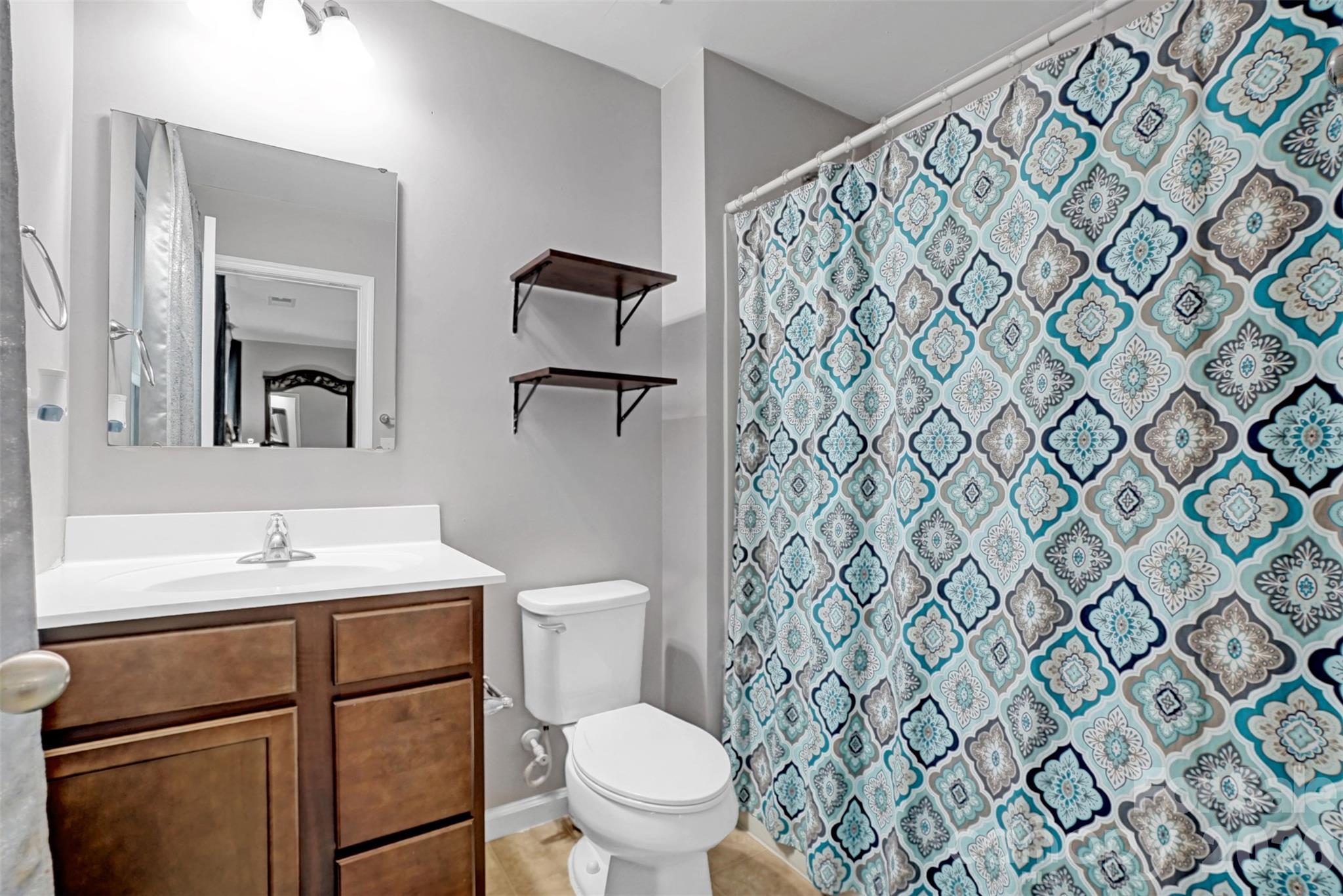 1144 Tangle Ridge Drive Southeast Concord, NC 28025 - Photo 16 of 27 a bathroom with a sink toilet and mirror