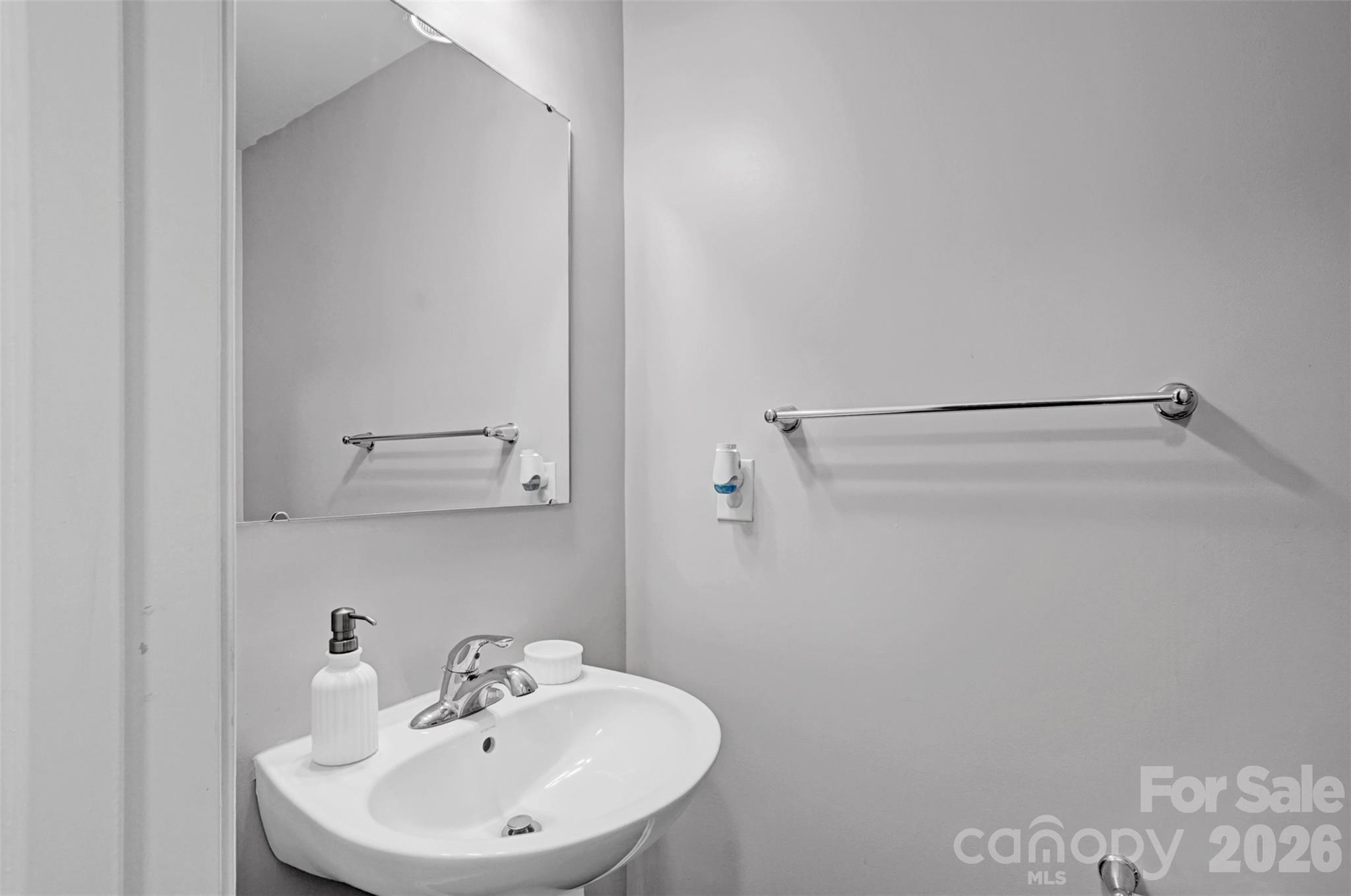 1144 Tangle Ridge Drive Southeast Concord, NC 28025 - Photo 17 of 27 a bathroom with a sink and mirror