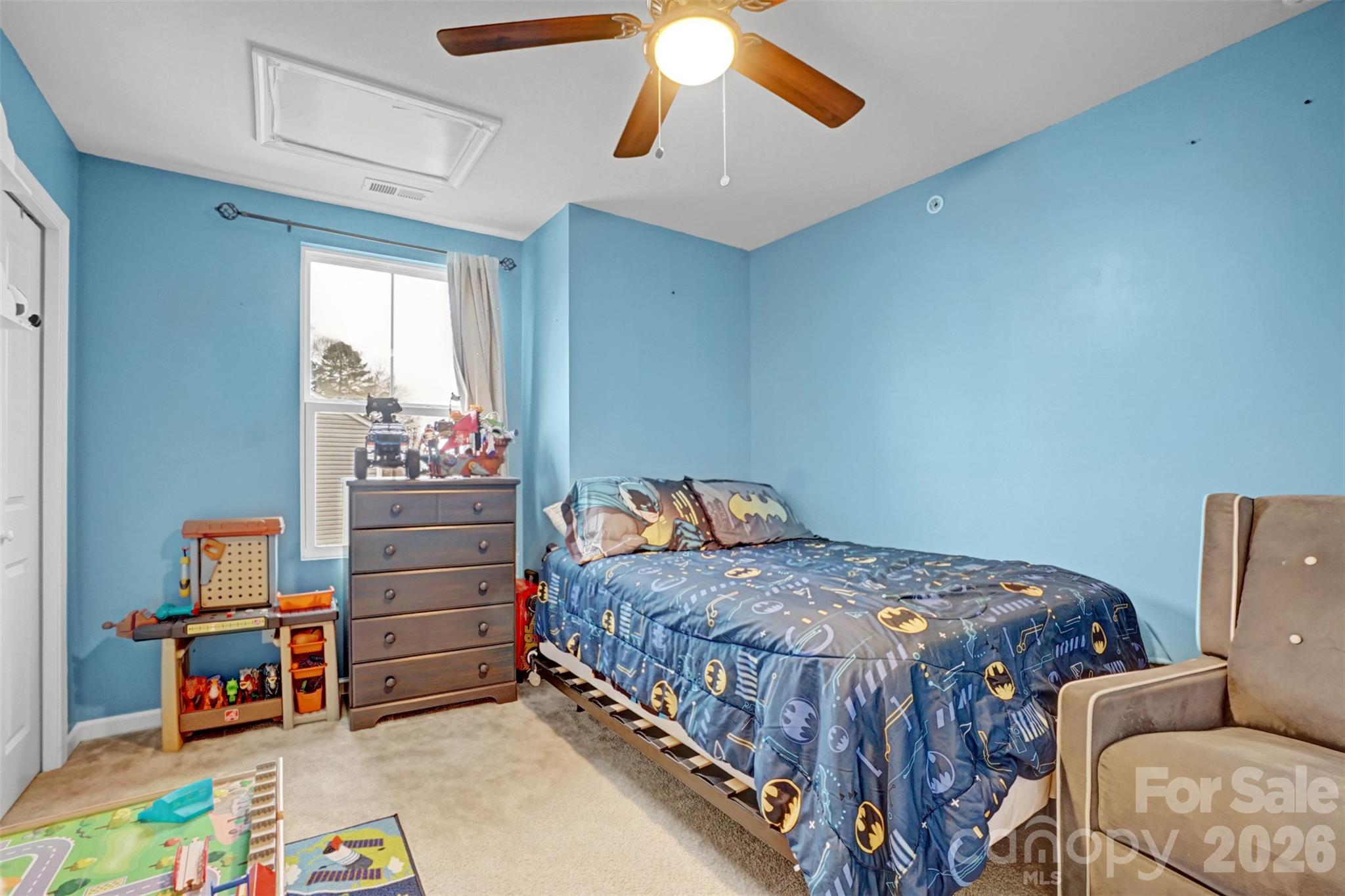 1144 Tangle Ridge Drive Southeast Concord, NC 28025 - Photo 19 of 27 a bedroom with a bed and a chandelier