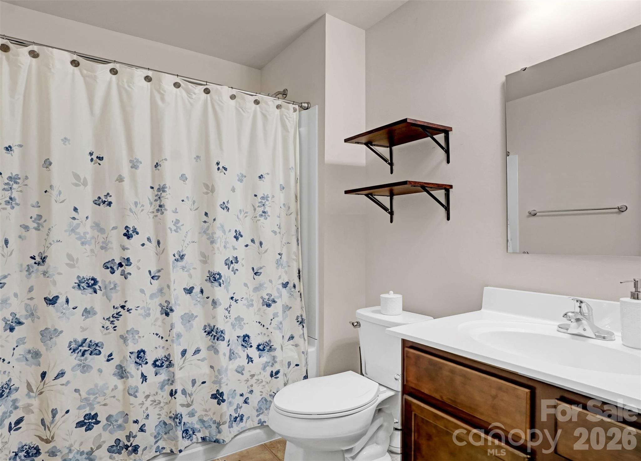 1144 Tangle Ridge Drive Southeast Concord, NC 28025 - Photo 21 of 27 a bathroom with a sink toilet and a mirror