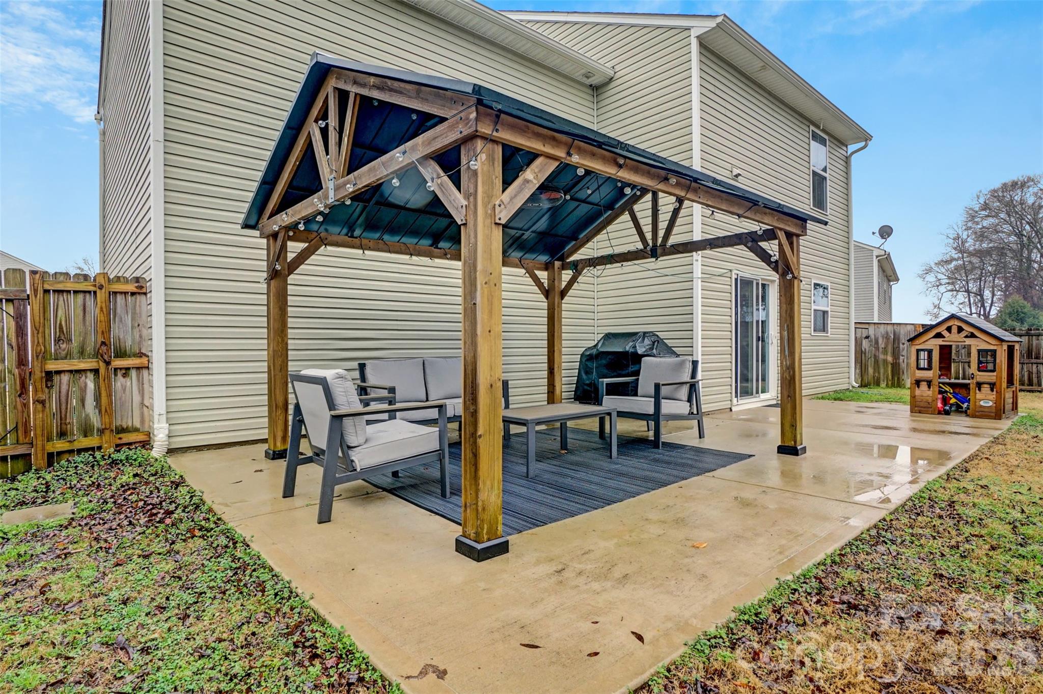 1144 Tangle Ridge Drive Southeast Concord, NC 28025 - Photo 22 of 27 a view of a house with backyard and sitting area