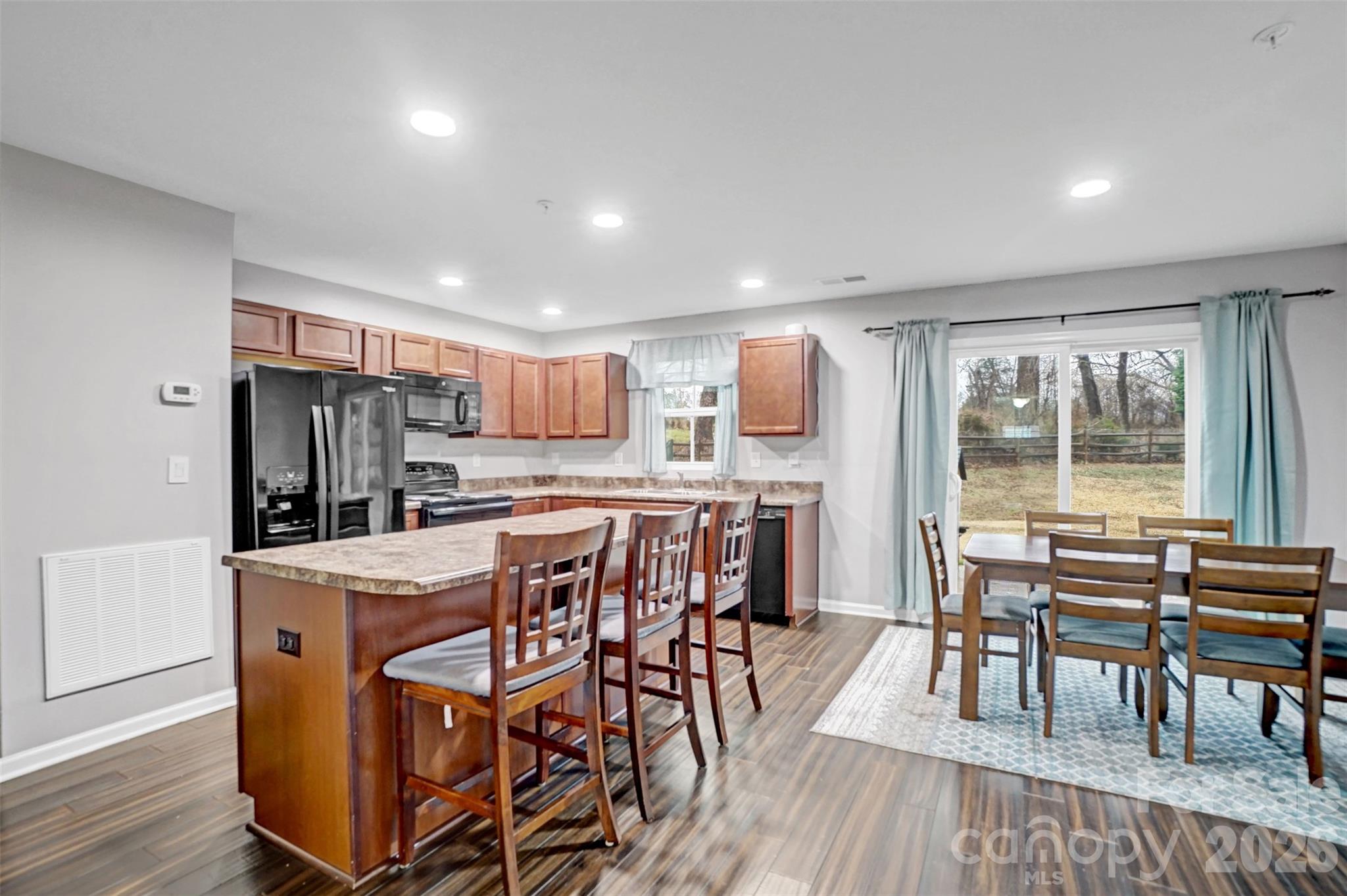 1144 Tangle Ridge Drive Southeast Concord, NC 28025 - Photo 8 of 27 a view of a dining room with furniture window and wooden floor