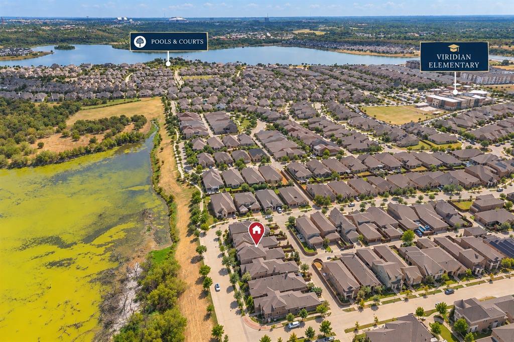 1205 Ivy Charm Way Arlington, TX 76005 - Photo 38 of 40 Aerial overview of a residential neighborhood featuring numerous single-family homes, a prominent lake, and community amenities