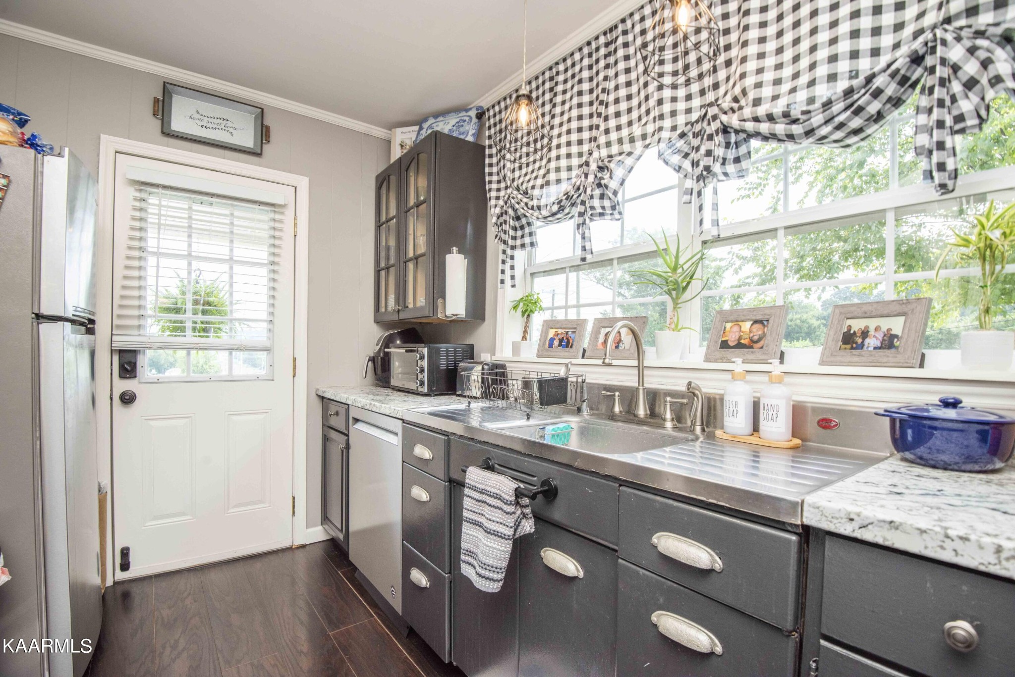 425 Clifton Road Northwest Knoxville, TN 37921 - Photo 14 of 38 a kitchen with stainless steel appliances granite countertop a sink window and cabinets