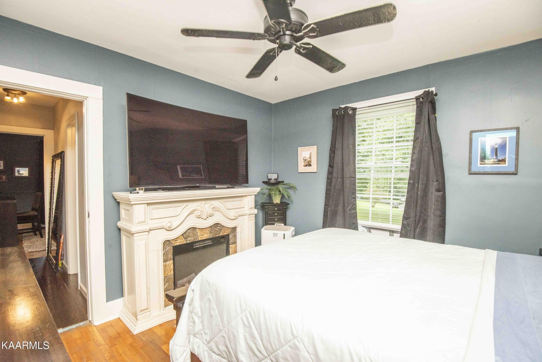 425 Clifton Road Northwest Knoxville, TN 37921 - Photo 19 of 38 a bedroom with a bed and a flat screen tv