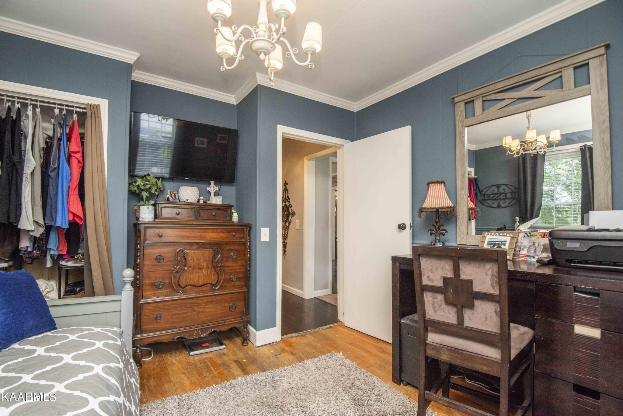 425 Clifton Road Northwest Knoxville, TN 37921 - Photo 23 of 38 a living room with furniture a flat screen tv and a chandelier