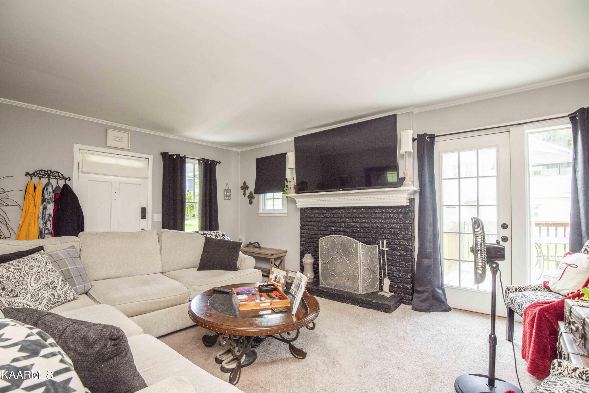 425 Clifton Road Northwest Knoxville, TN 37921 - Photo 7 of 38 a living room with furniture a fireplace and a flat screen tv