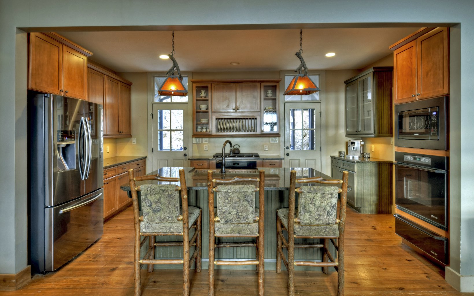 773 Heards Ridge Morganton, GA 30560 - Photo 15 of 54 a kitchen with stainless steel appliances kitchen island granite countertop a dining table chairs refrigerator and sink