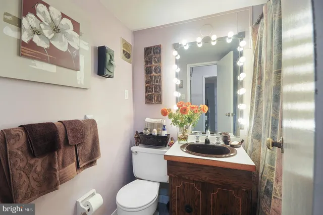 a bathroom with a toilet sink and mirror