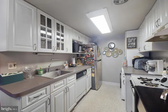 a kitchen with stainless steel appliances granite countertop a stove and cabinets