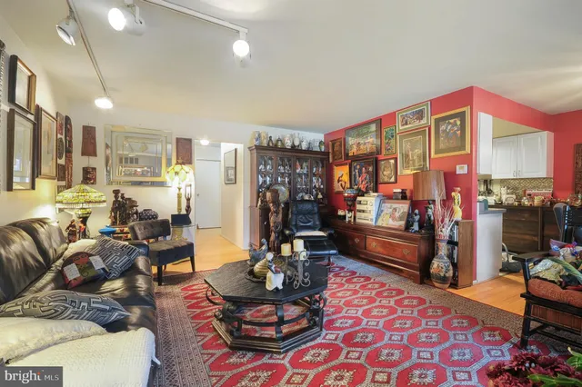 a living room with furniture a rug and a chandelier