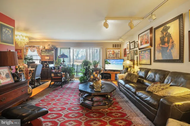 a living room with furniture fireplace and a large window
