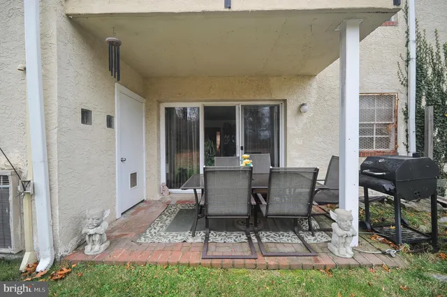 a view of backyard of house with seating space