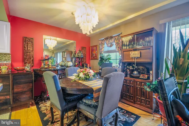 a view of a dining room with furniture and a potted plant