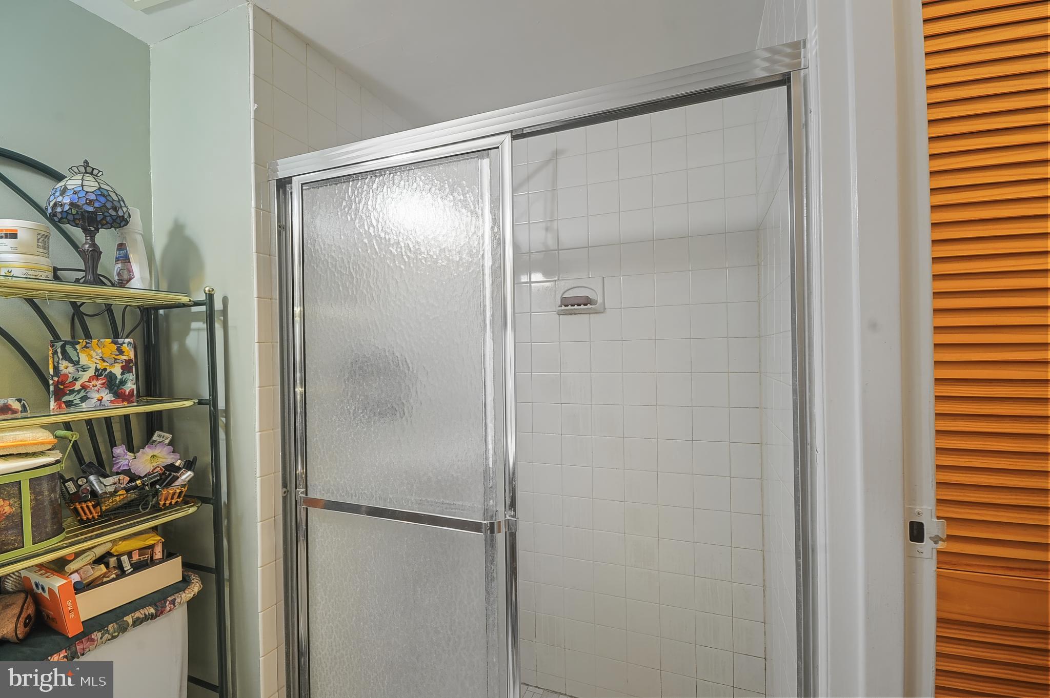7300 Cresheim Road, Unit C13 Philadelphia, PA 19119 - Photo 8 of 26 a bathroom with a glass shower door