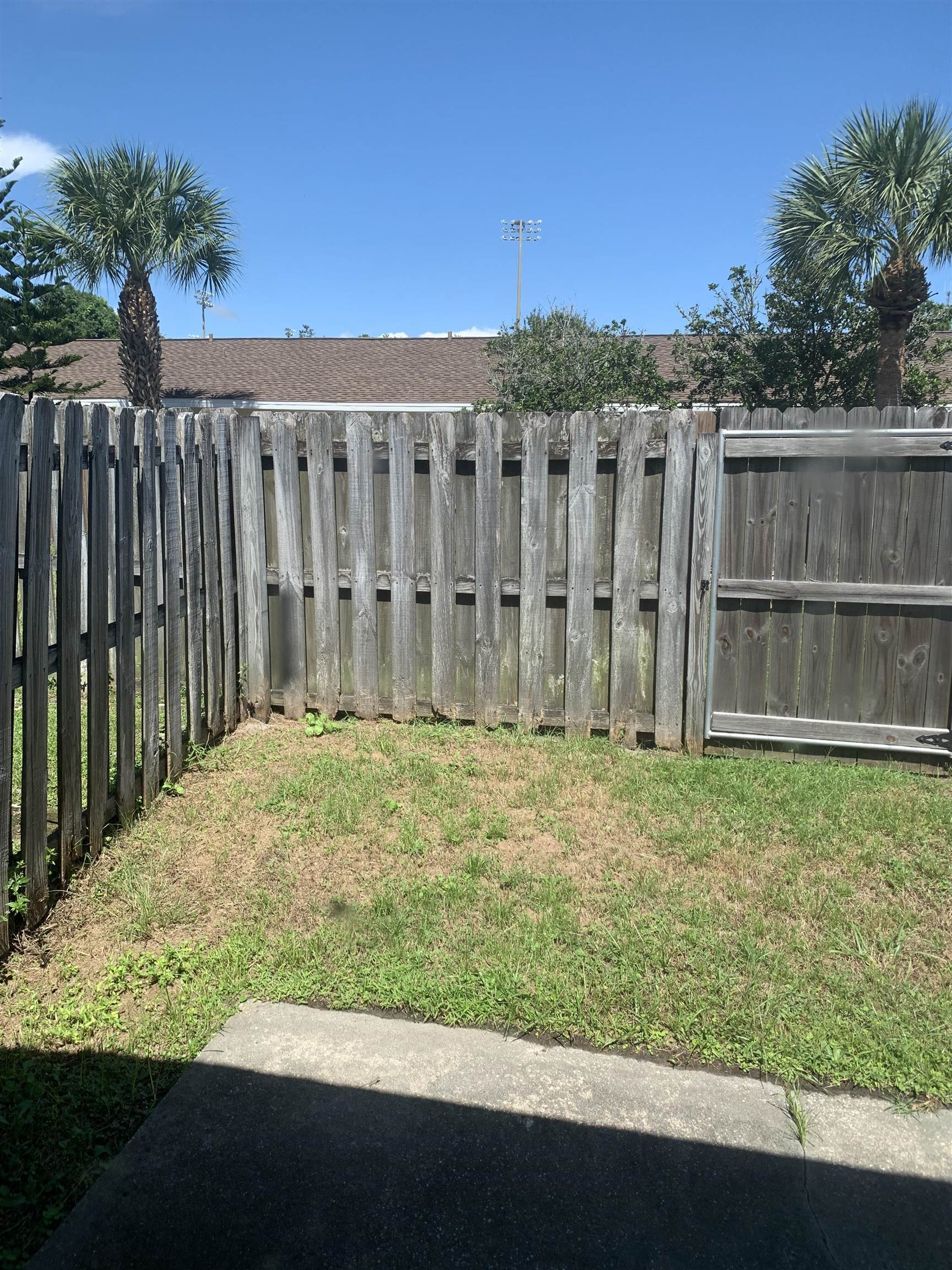 1845 Old Moultrie Road, Unit 30 St. Augustine, FL 32084 - Photo 13 of 15 a view of a backyard with wooden fence