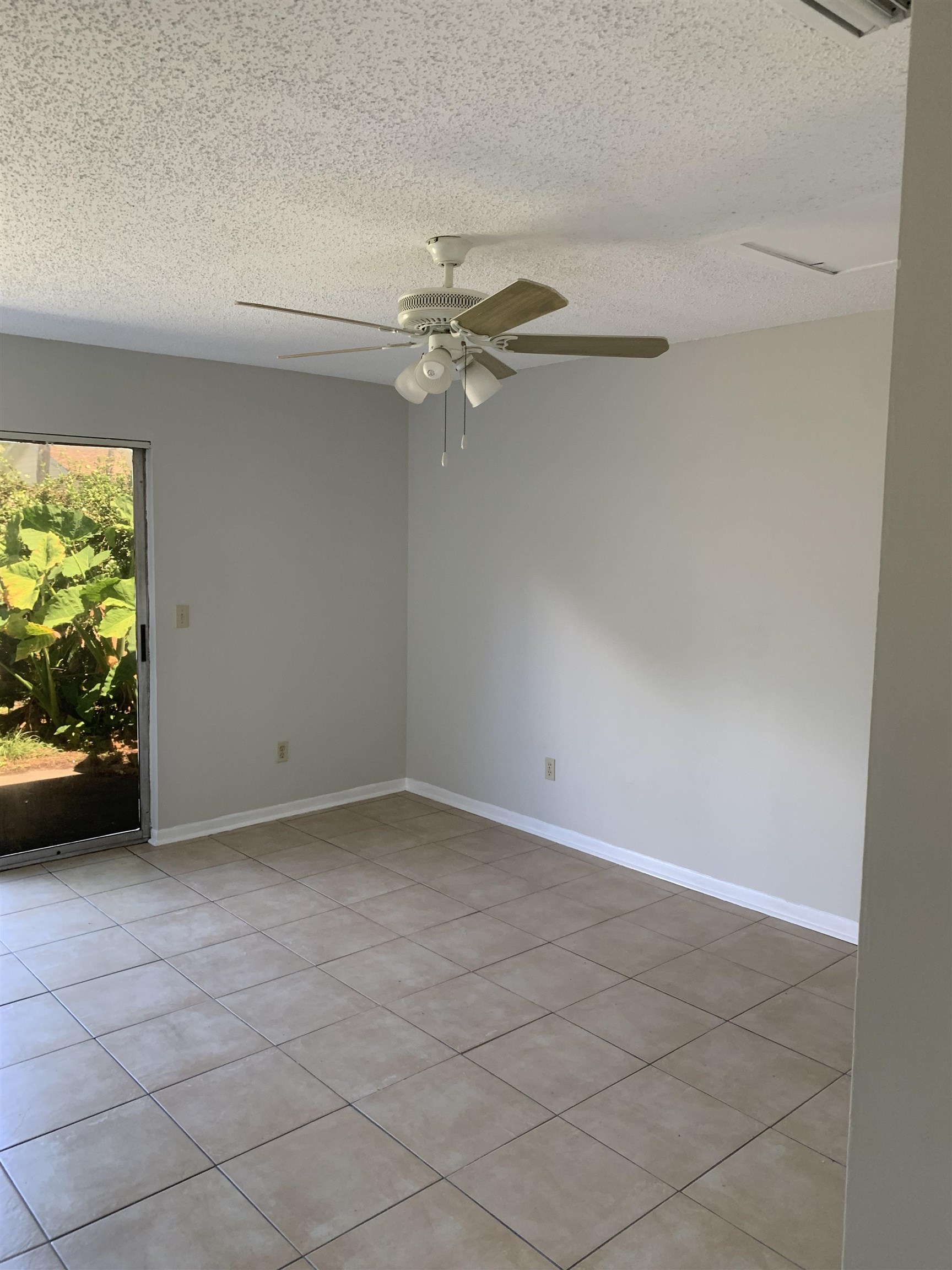 1845 Old Moultrie Road, Unit 30 St. Augustine, FL 32084 - Photo 14 of 15 an empty room with windows and fan