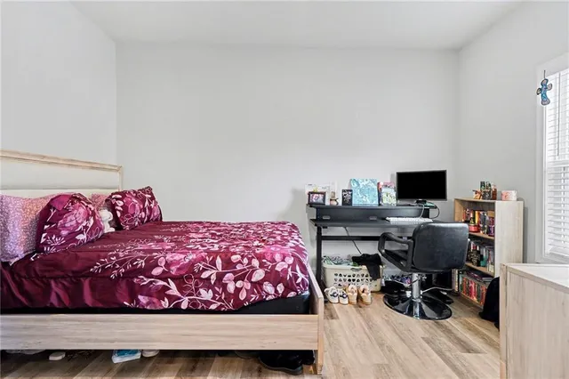 a bedroom with a bed and a desk