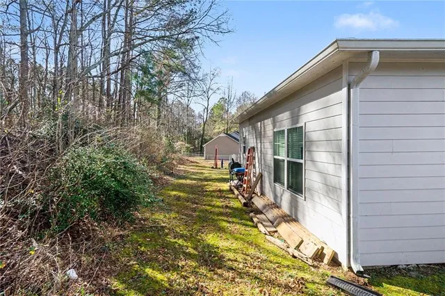 a view of an house with backyard space and balcony