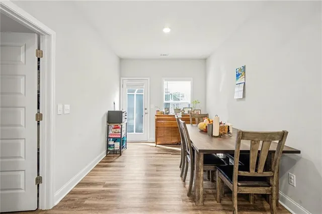 a view of a dining room with furniture and wooden floor